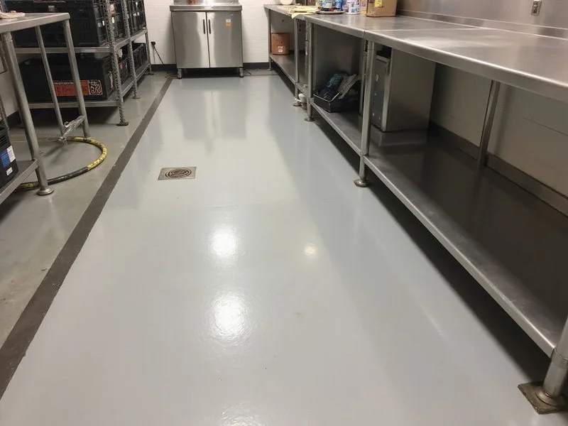 Commercial back-of-house area with a seamless epoxy floor and coved edge detail